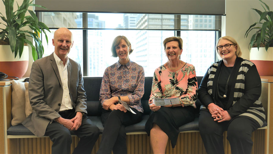 Graham, Marg, Anne and Cathy sitting together on a sofa smiling