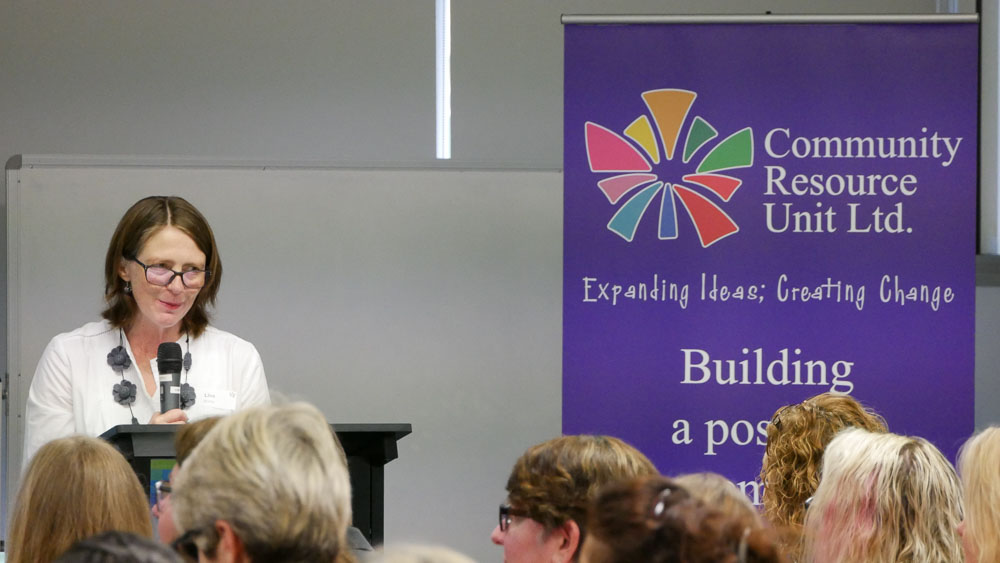 A lady speaking at a podium