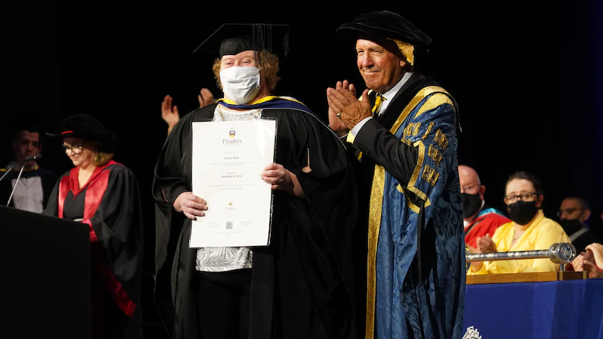 a person receiving an award at uni graduation