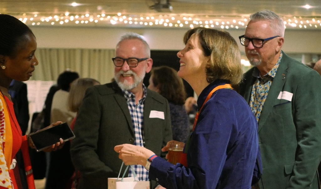 Marg Rodgers accepting a gift surrounded by three others in background.